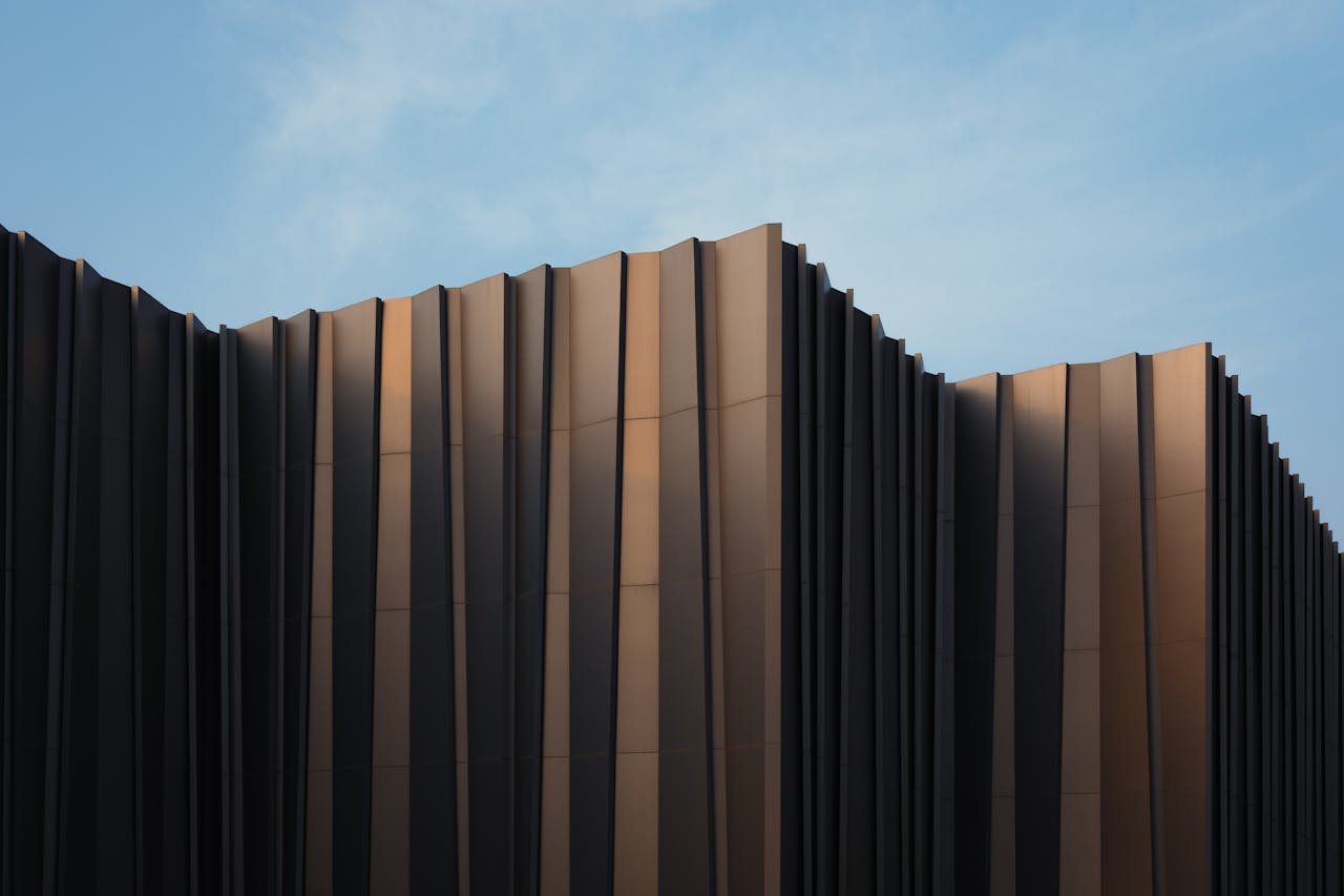 Mastering the First Impression: Your intriguing post title goes here Sleek modern building facade with unique design set against a clear blue sky.